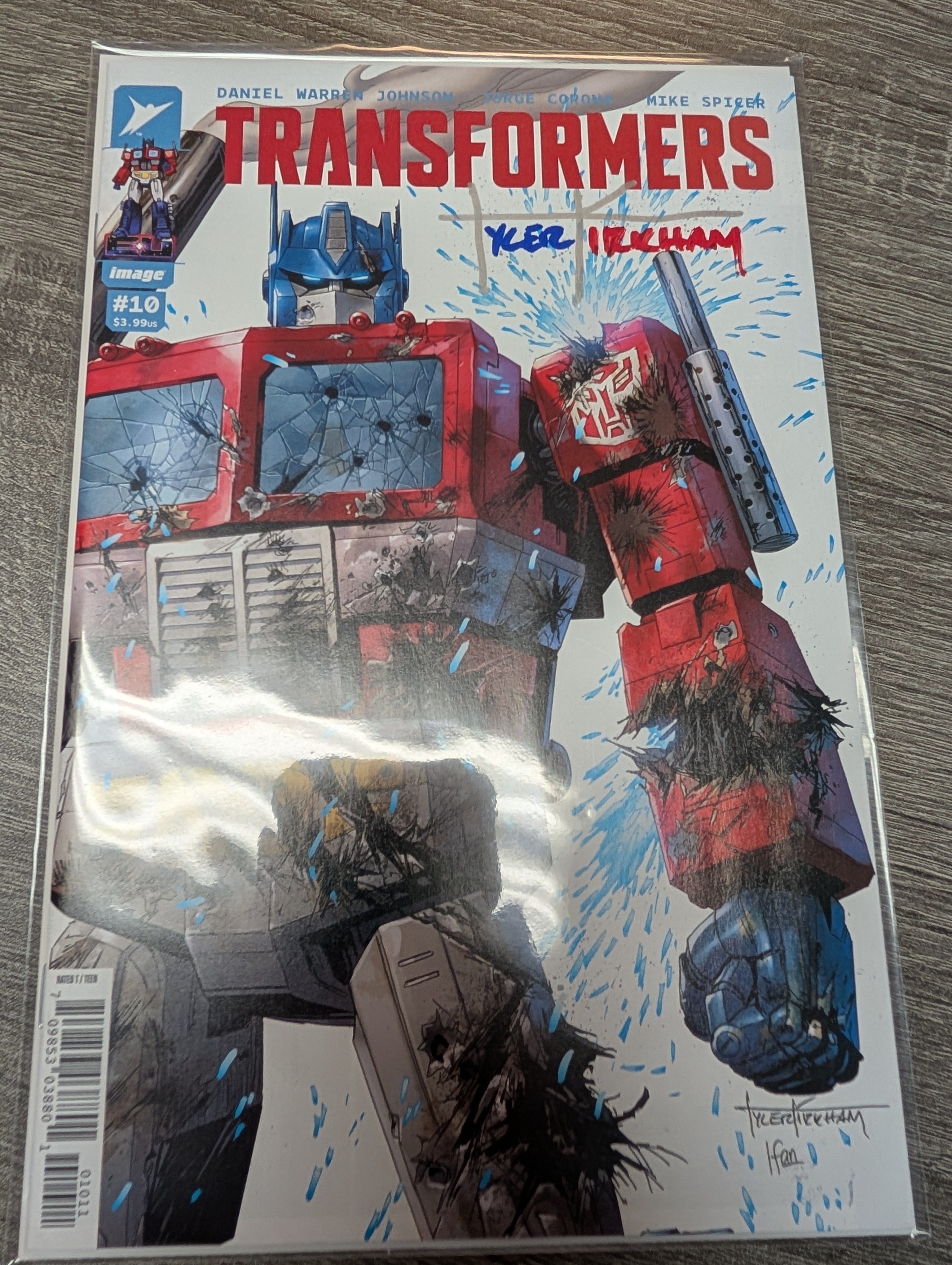Transformers #10 Signed Tyler Kirkham MegaCon 2026 Exclusive Battle Damaged Trade Dress Variant – Image Comics